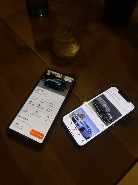 Drivable auf zwei iPhones: Fahrzeugdetail eines Audi RS6 und Suche in München