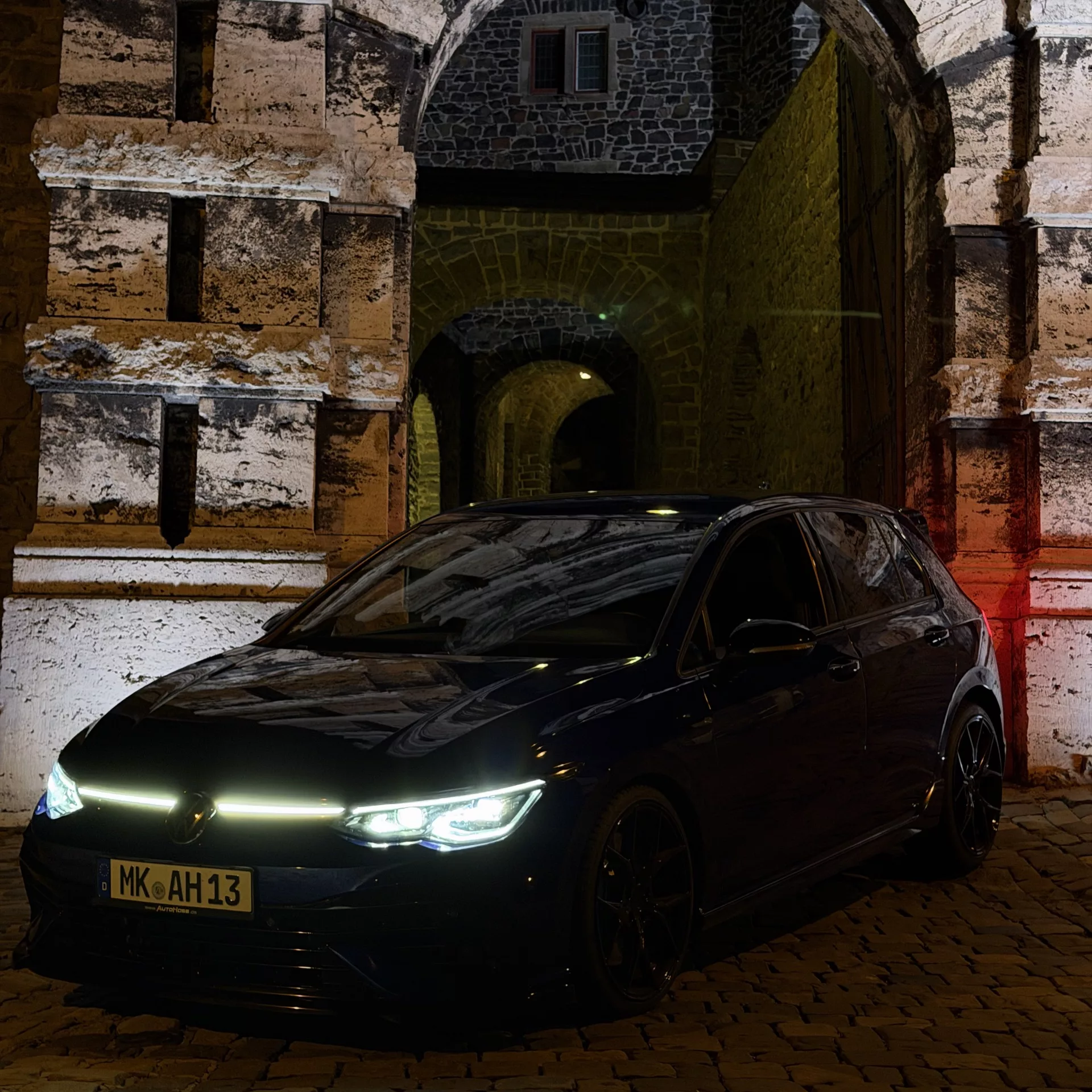 VW GOLF 8 R Performance in Dunkelblau vor historischem Gebäude mieten.