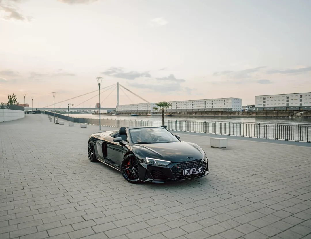 Audi R8 Cabrio V10 in Schwarz, Frontansicht am Wasser mieten.