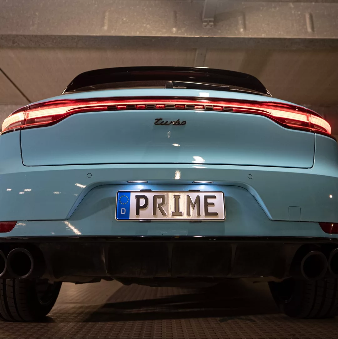 Porsche Macan Turbo Sportabgasanlage in Blau von hinten mieten.