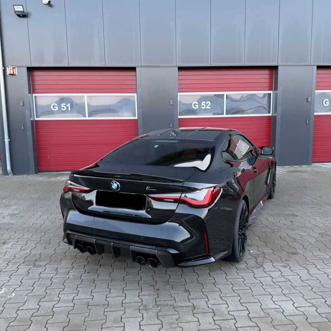 BMW M4 Competition XDrive in Schwarz, Heckansicht mieten