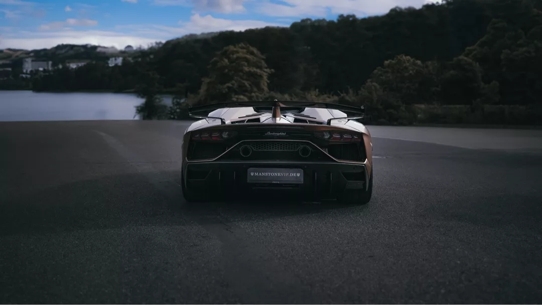 Lamborghini Aventador SVJ Roadster in Berlin mieten - Heckansicht auf der Straße mieten