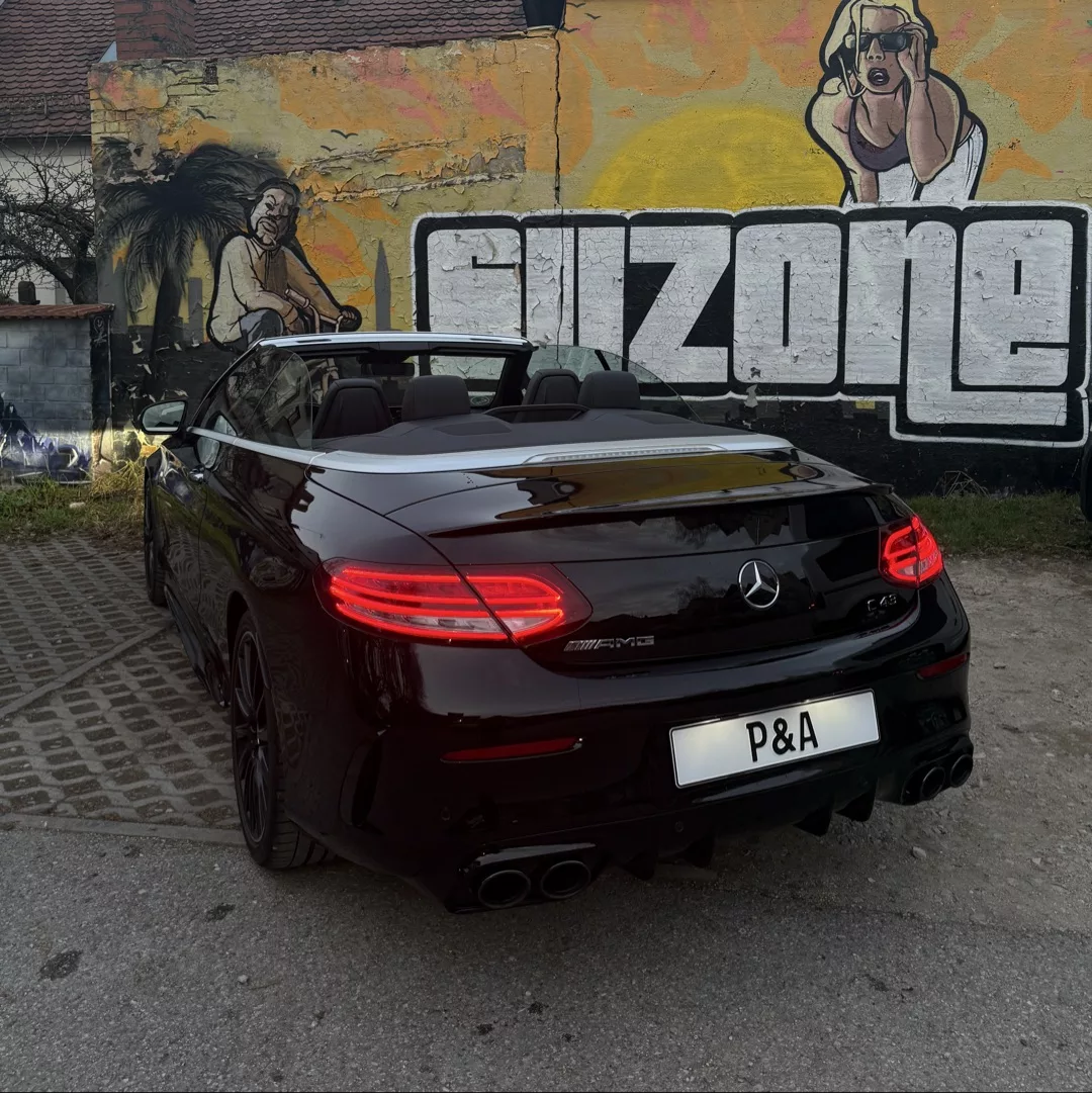 Mercedes C43 AMG Cabrio in Schwarz, Heckansicht, gemietet.