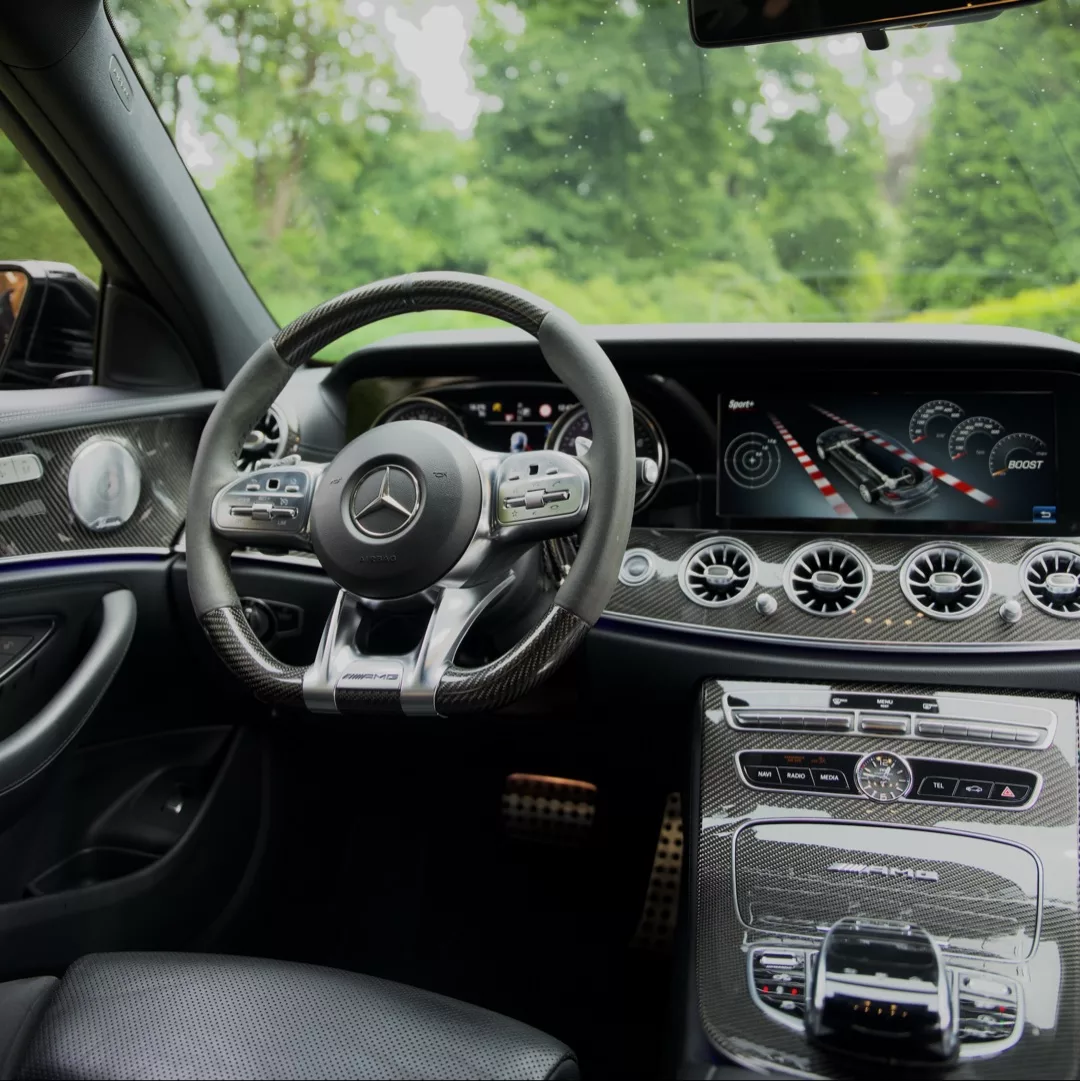 Mercedes AMG E63s Cockpitansicht mit Lenkrad und Armaturenbrett mieten.