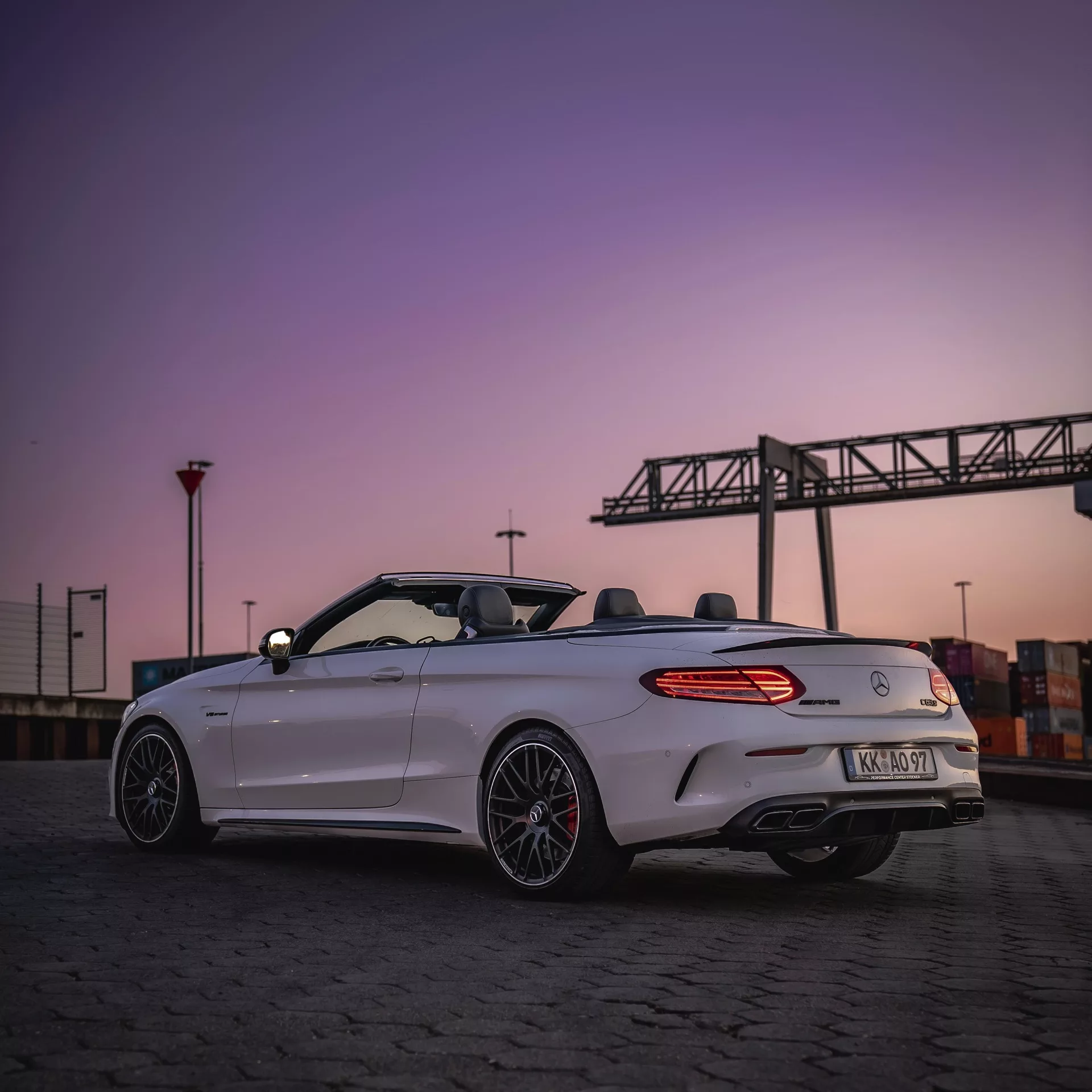 Mercedes C63s Cabrio in Weiß bei Sonnenuntergang mieten.